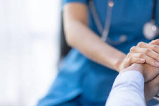 Cropped shot of a female nurse hold her senior patient's hand. Giving Support. Doctor helping old patient with Alzheimer's disease. Female carer holding hands of senior man